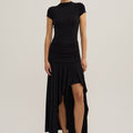 Woman wearing a black dress with a plain background